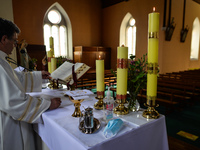 Father Krzysztof Sikora during a private prayer at the closed and empty Roman Catholic Church 'Our Lady Star Of The Sea' in Roundstone. Due...