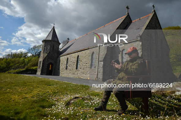 Father Krzysztof Sikora checks his mobile phone outside St James's Church, in Cashel, Connemara.

Geographically, Roundstone parish is consi...