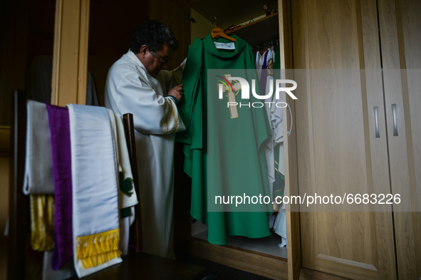 Father Krzysztof Sikora inspects the chasuble in the sacristy of the Roman Catholic Church 'Our Lady Star Of The Sea' in Roundstone, Connema...