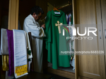 Father Krzysztof Sikora inspects the chasuble in the sacristy of the Roman Catholic Church 'Our Lady Star Of The Sea' in Roundstone, Connema...