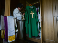 Father Krzysztof Sikora inspects the chasuble in the sacristy of the Roman Catholic Church 'Our Lady Star Of The Sea' in Roundstone, Connema...