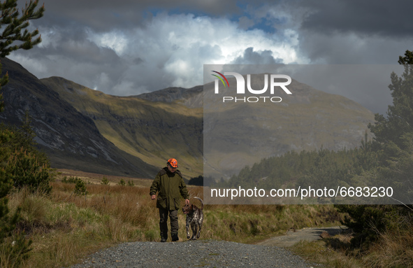 Father Krzysztof Sikora walks his dog 'Rambo' near Barnanoraun townland, near the Owenglin River.

Geographically, Roundstone parish is cons...