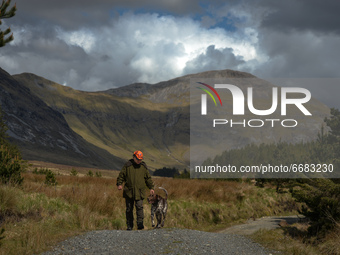 Father Krzysztof Sikora walks his dog 'Rambo' near Barnanoraun townland, near the Owenglin River.

Geographically, Roundstone parish is cons...