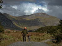 Father Krzysztof Sikora walks his dog 'Rambo' near Barnanoraun townland, near the Owenglin River.

Geographically, Roundstone parish is cons...