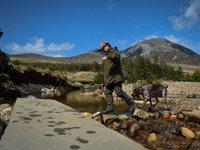 Father Krzysztof Sikora walks his dog 'Rambo' near Barnanoraun townland, along the Owenglin River.

Geographically, Roundstone parish is con...