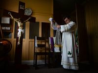 Father Krzysztof Sikora is getting ready for private prayer at the closed Roman Catholic Church 'Our Lady Star Of The Sea' in Roundstone. Du...