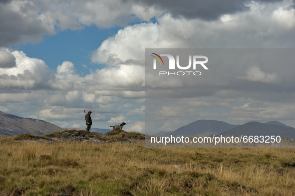 Father Krzysztof Sikora seen with his dog 'Rambo' near to the Gowla Fishery, situated in central Connemara, among one of the most beautiful...