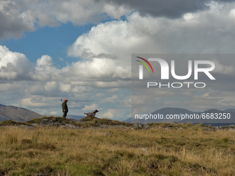 Father Krzysztof Sikora seen with his dog 'Rambo' near to the Gowla Fishery, situated in central Connemara, among one of the most beautiful...