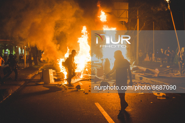 Demonstrators clash with riot police during a protest against President Ivan Duque's government in Pereira, Colombia on May 05, 2021. 