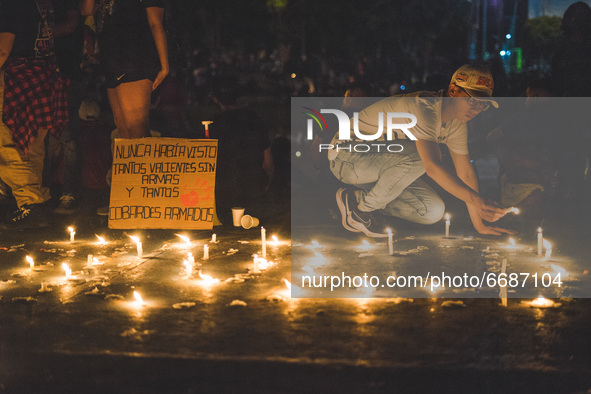 Protesters gather to paid tribute to the people who pass away at the protest with candles and flowers, rejecting the violence during a natio...
