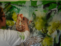 Chelsea Jacobs aka Chels, an American artist living in Dublin, works on a new oil painting of a man feeding pigeons in St Stephen's Green, D...