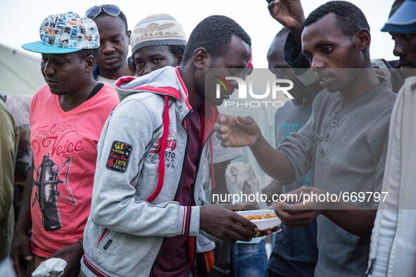 A migrant eat at the end of Ramadan, in Ventimiglia, on the French-Italian border, on June 23, 2015. The situation of migrants camped in Ven...