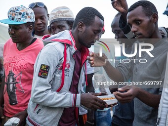 A migrant eat at the end of Ramadan, in Ventimiglia, on the French-Italian border, on June 23, 2015. The situation of migrants camped in Ven...