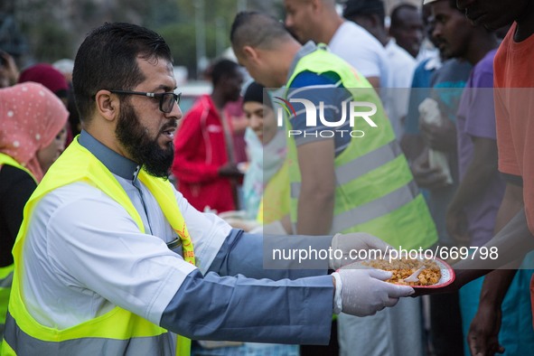 A member Assosiacion du Fraternitè Du Savoir help a migrant in Ventimiglia, on the French-Italian border, on June 23, 2015. The situation of...