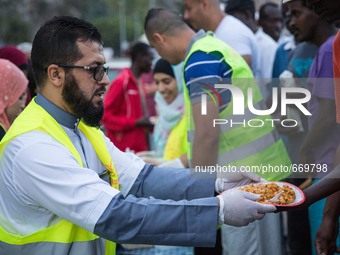 A member Assosiacion du Fraternitè Du Savoir help a migrant in Ventimiglia, on the French-Italian border, on June 23, 2015. The situation of...