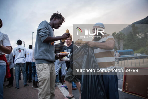 A member Assosiacion du Fraternitè Du Savoir help a migrant in Ventimiglia, on the French-Italian border, on June 23, 2015. The situation of...