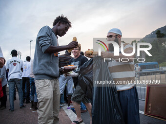 A member Assosiacion du Fraternitè Du Savoir help a migrant in Ventimiglia, on the French-Italian border, on June 23, 2015. The situation of...