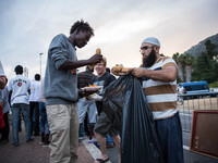 A member Assosiacion du Fraternitè Du Savoir help a migrant in Ventimiglia, on the French-Italian border, on June 23, 2015. The situation of...