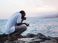 A migrant waits near the sea, in the city of Ventimiglia at the French-Italian border, on June 23, 2015. The situation of migrants camped in...