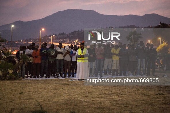 Migrants pray near the sea in the city of Ventimiglia on the French-Italian border, on June 23, 2015. The situation of migrants camped in Ve...