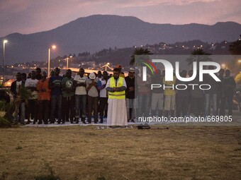 Migrants pray near the sea in the city of Ventimiglia on the French-Italian border, on June 23, 2015. The situation of migrants camped in Ve...