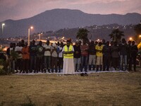 Migrants pray near the sea in the city of Ventimiglia on the French-Italian border, on June 23, 2015. The situation of migrants camped in Ve...