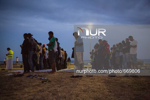 Migrants pray near the sea in the city of Ventimiglia on the French-Italian border, on June 23, 2015. The situation of migrants camped in Ve...