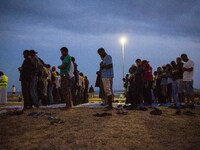 Migrants pray near the sea in the city of Ventimiglia on the French-Italian border, on June 23, 2015. The situation of migrants camped in Ve...