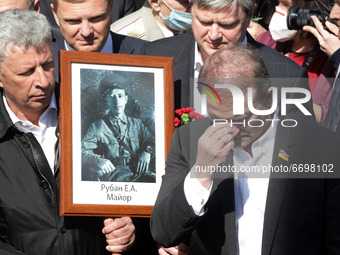 Viktor Medvedchuk, a leader of Opposition Platform-For life, (R) prays as Yuriy Boyko (L) holds a veteran's portrait during flowers-laying c...