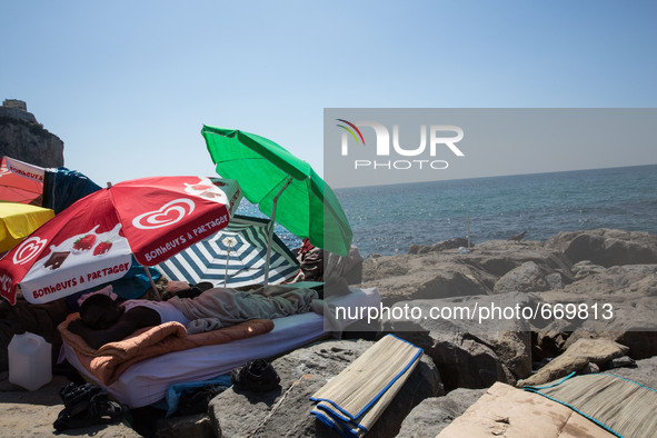 A migrant sleep near the sea, in the city of Ventimiglia at the French-Italian border, on June 24, 2015. The situation of migrants camped in...