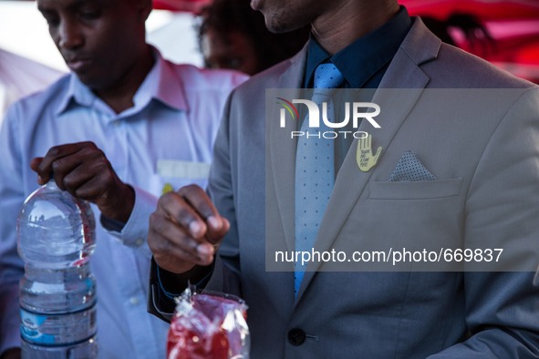 A man with brooch pin written "Touch Pas a Mon Pote" (Don't Touch My friend), in the city of Ventimiglia at the French-Italian border, on Ju...