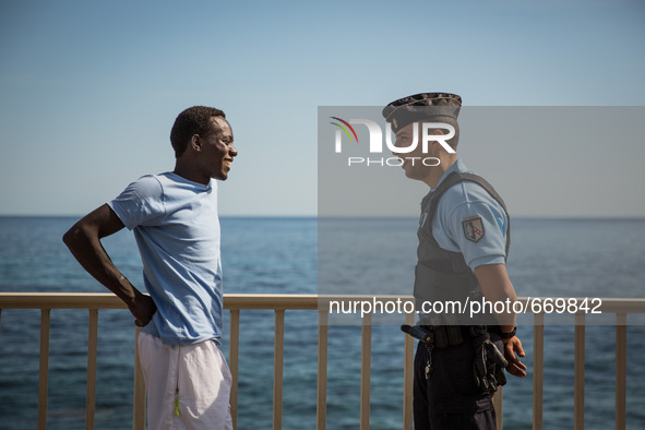 A migrant talk with a guard in Ventimiglia, border to Menton, on June 25, 2015. The situation of migrants camped in Ventimiglia has not chan...