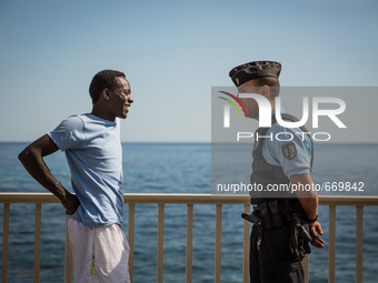 A migrant talk with a guard in Ventimiglia, border to Menton, on June 25, 2015. The situation of migrants camped in Ventimiglia has not chan...