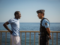 A migrant talk with a guard in Ventimiglia, border to Menton, on June 25, 2015. The situation of migrants camped in Ventimiglia has not chan...