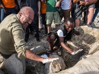 Vauro (L) famous political cartoonist, made an art installation on the rocks where migrants are, in Ventimiglia on June 25, 2015. The situat...