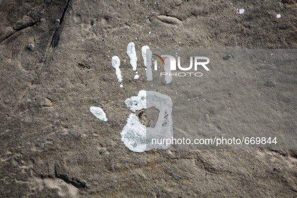 An art installation of Vauro on the rocks where migrants are, in the city of Ventimiglia at the French-Italian border, on June 25, 2015. The...