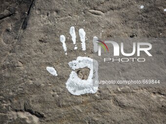 An art installation of Vauro on the rocks where migrants are, in the city of Ventimiglia at the French-Italian border, on June 25, 2015. The...