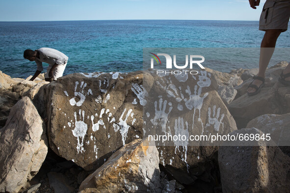 An art installation of Vauro on the rocks where migrants are, in the city of Ventimiglia at the French-Italian border, on June 25, 2015. The...