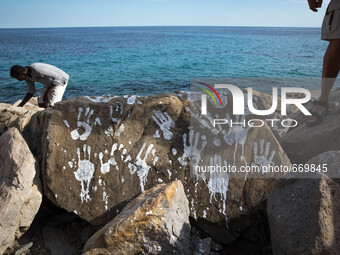 An art installation of Vauro on the rocks where migrants are, in the city of Ventimiglia at the French-Italian border, on June 25, 2015. The...