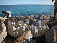 An art installation of Vauro on the rocks where migrants are, in the city of Ventimiglia at the French-Italian border, on June 25, 2015. The...