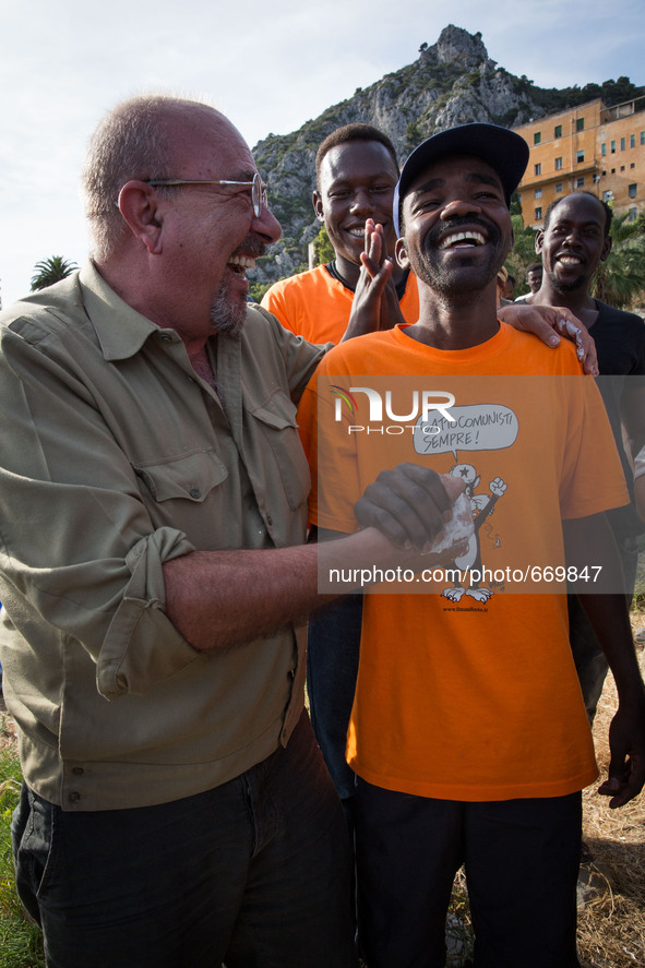 Vauro (L) famous political cartoonist, made an art installation on the rocks where migrants are, in Ventimiglia on June 25, 2015. The situat...