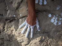 An art installation of Vauro on the rocks where migrants are, in the city of Ventimiglia at the French-Italian border, on June 25, 2015. The...