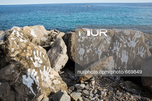 Handprints (an art installation of Vauro) on the rocks where migrants are, in the city of Ventimiglia at the French-Italian border, on June...