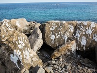 Handprints (an art installation of Vauro) on the rocks where migrants are, in the city of Ventimiglia at the French-Italian border, on June...