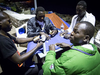 Migrants plays near the rocks where they sleep, in Ventimiglia, on June 27, 2015.  The situation of migrants camped in Ventimiglia has not c...