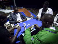 Migrants plays near the rocks where they sleep, in Ventimiglia, on June 27, 2015.  The situation of migrants camped in Ventimiglia has not c...