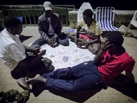 Migrants plays near the rocks where they sleep, in Ventimiglia, on June 27, 2015.  The situation of migrants camped in Ventimiglia has not c...