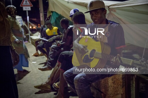 Migrants plays near the rocks where they sleep, in Ventimiglia, on June 27, 2015. The situation of migrants camped in Ventimiglia has not ch...