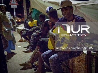 Migrants plays near the rocks where they sleep, in Ventimiglia, on June 27, 2015. The situation of migrants camped in Ventimiglia has not ch...