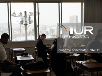 Buildings of Hiroshima downtown are viewed through classroom windows as students attend a lecture at Hiroshima Korean School on May 9, 2021...